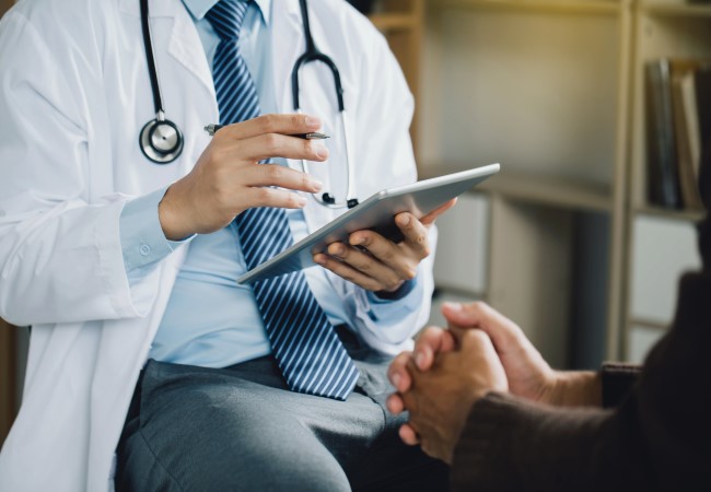 Psychiatrist inputting information from a patient in a digital tablet