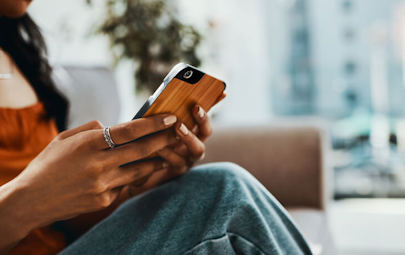 cropped image of woman using her smart phone cropped image of woman using her smart phone