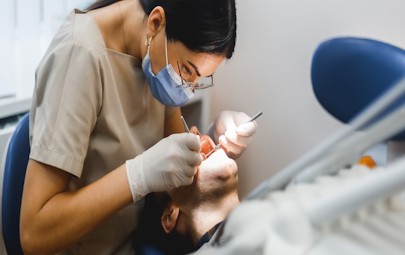 Dentist working with a patient Dentist working with a patient