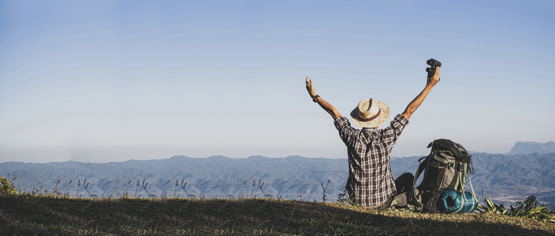 An adventurous male enjoying view from of the mountaintop