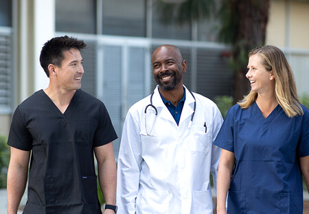 Doctor walking with nurses