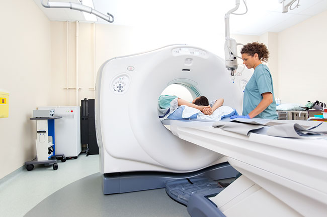 MRI Tech working with a patient during a scan