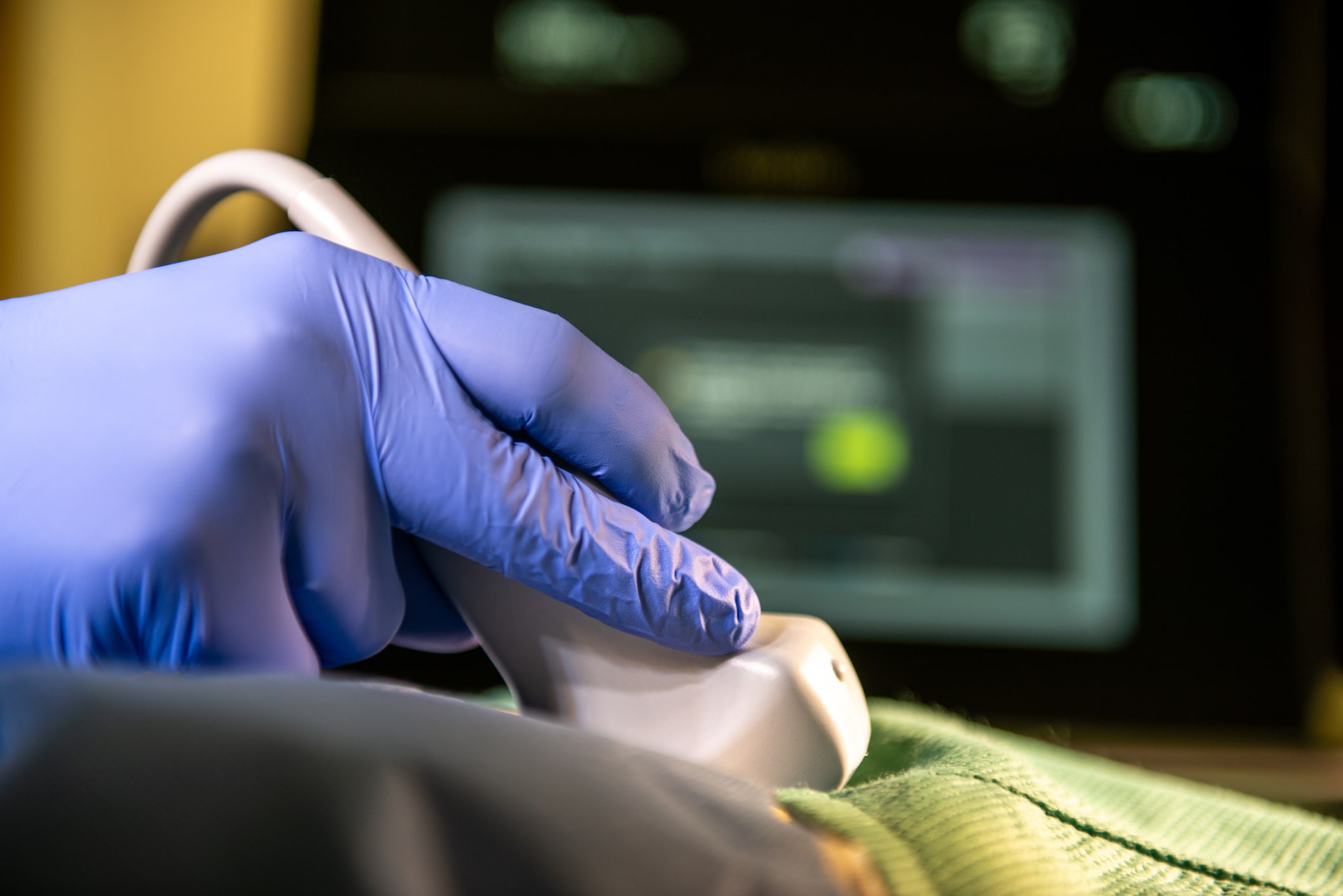 Medical sonographer checking patient