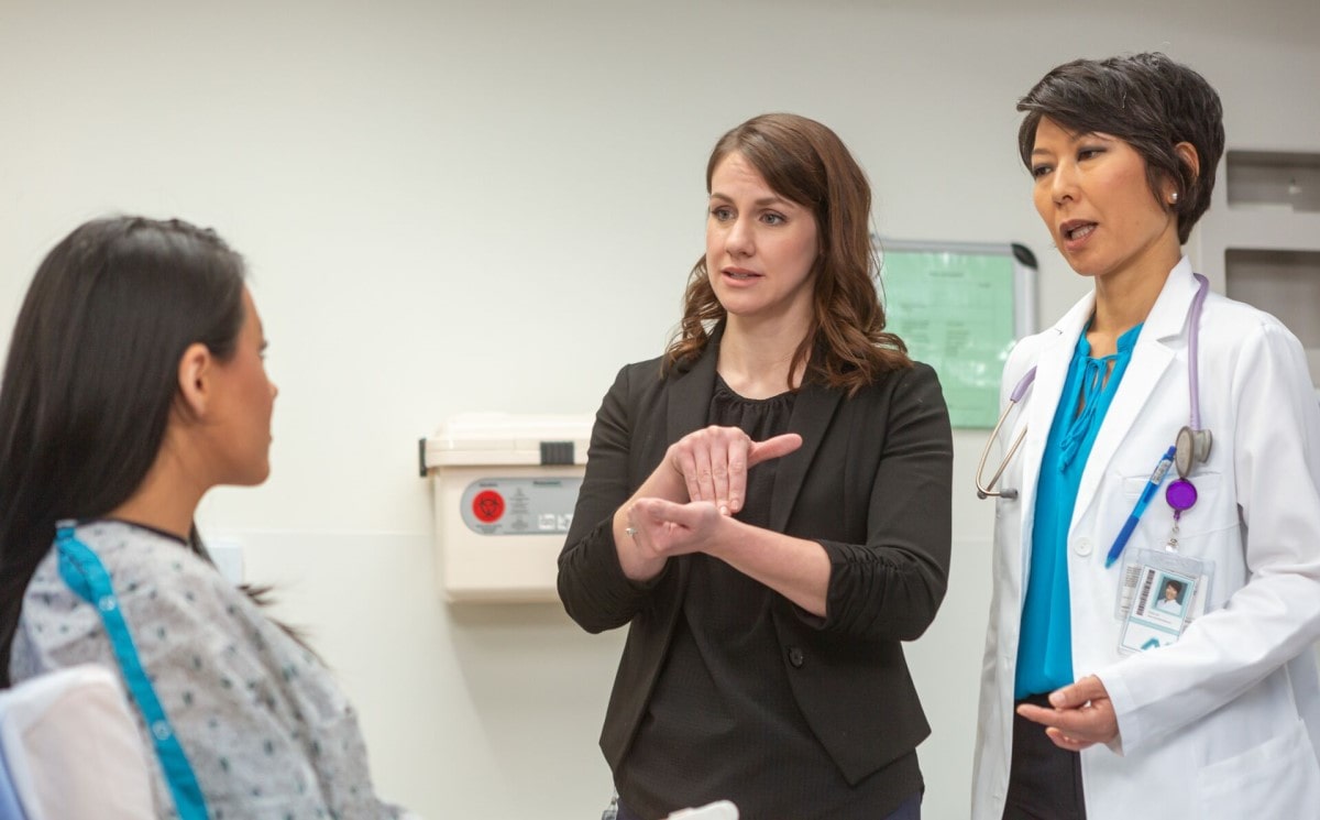 An interpreter working with a patient in a medical setting