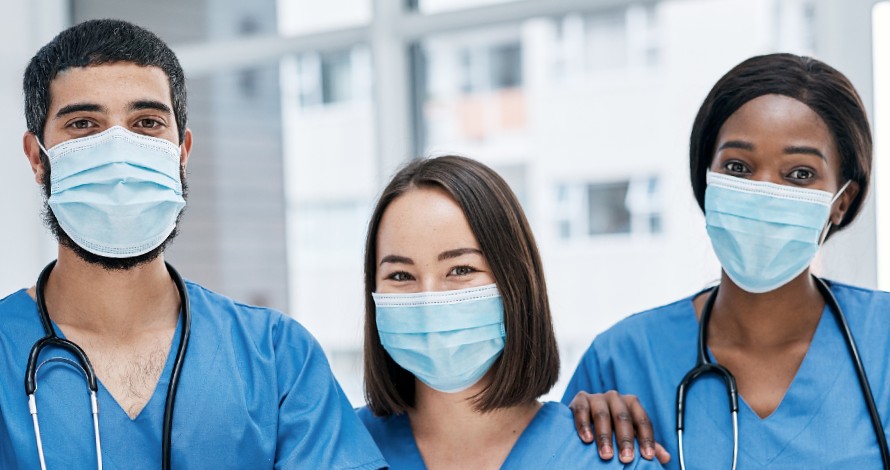 three nurses with scrubs and face masks three nurses with scrubs and face masks