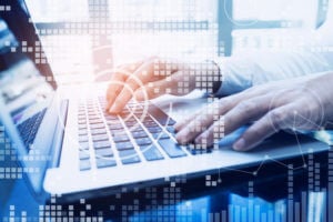 Man's hands on a laptop keyboard with computer dots overlaid on image to evoke technology