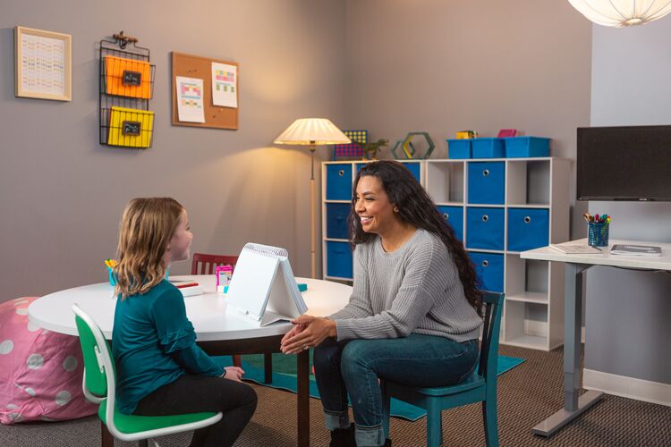 speech language pathologist working with school-aged child