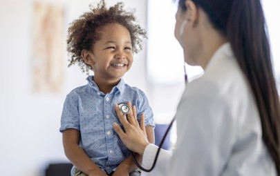 a nurse practitioner using a stethoscope to listen to a toddlers heart a nurse practitioner using a stethoscope to listen to a toddlers heart