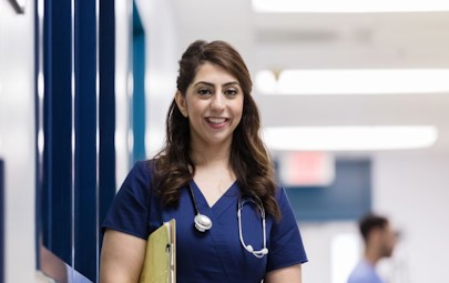 Happy nurse practitioner in a hospital Happy nurse practitioner in a hospital