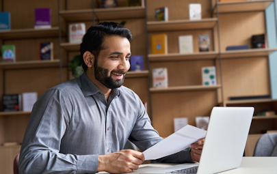 Man sitting in front of a computer studying Man sitting in front of a computer studying
