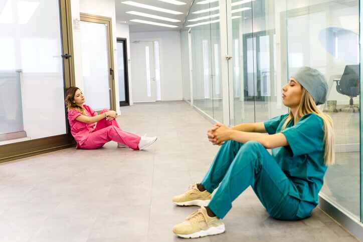 2 fatigue nurses sitting on the ground 2 fatigue nurses sitting on the ground