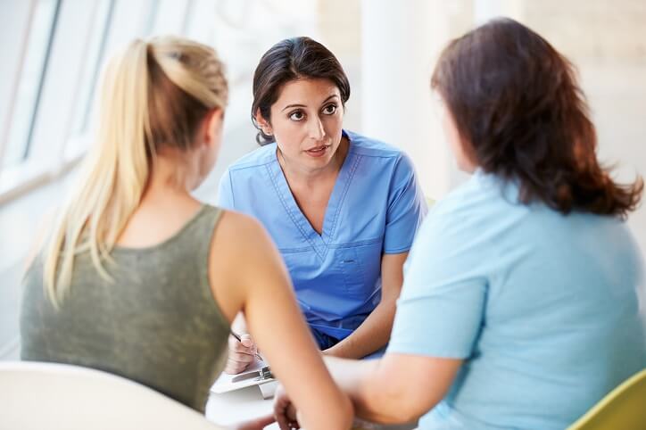 Nurse talking with a patient's family.