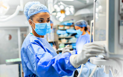 physician looking at a monitor physician looking at a monitor