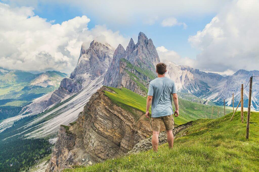 a man directly looking at the mountains in the distance