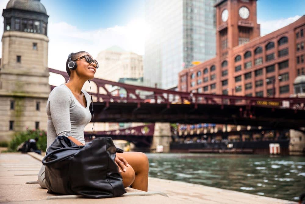 woman listening to music at chicago river