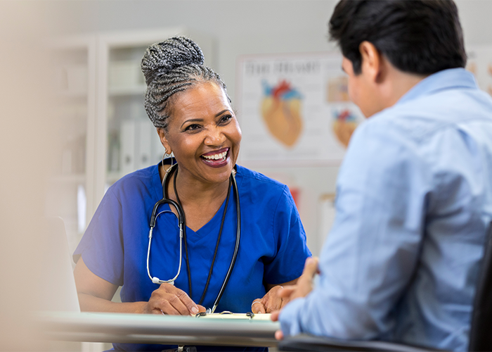 Two clinicians consulting with each other at a desk