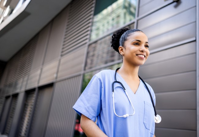 Travel nurse walking in a hospital setting