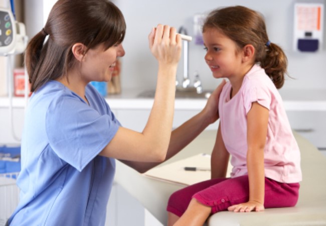 Pediatric Nurse sitting with patient