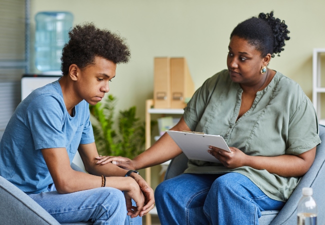 Therapist working with teenage boy 