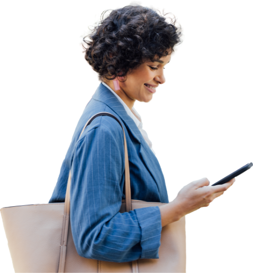 Healthcare Professional walking with her bag while on her phone.