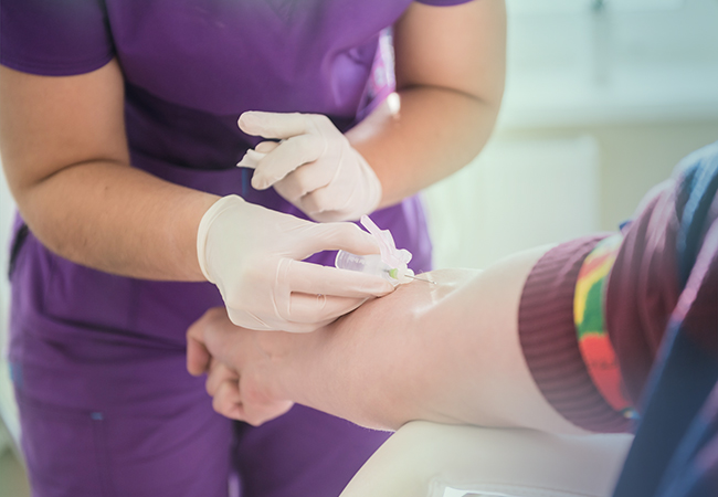 Nurse drawing blood from patient