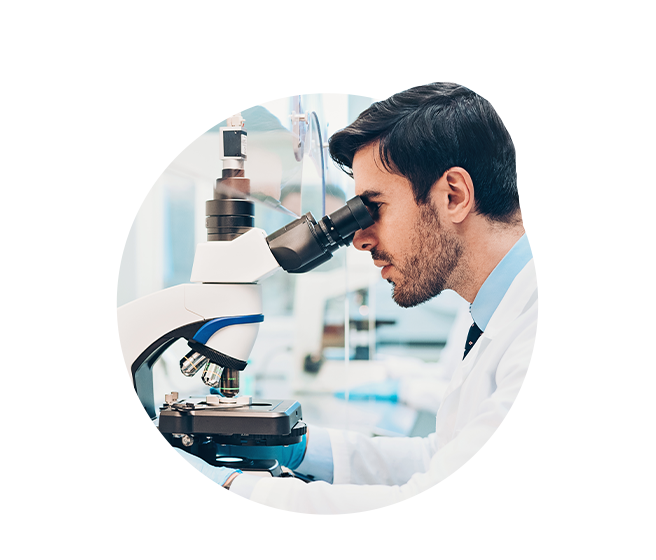 Doctor looking through microscope