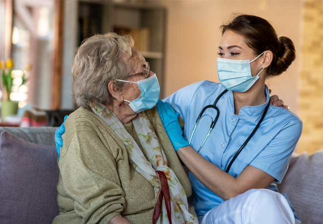Home health nurse on couch with patient