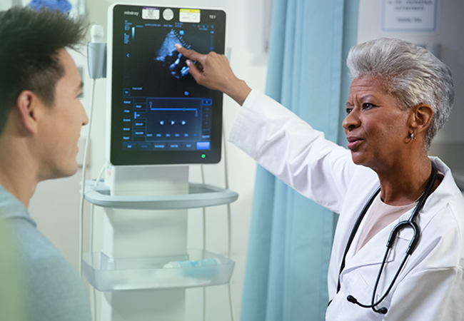 Female permanent physician showing doctor an x-ray