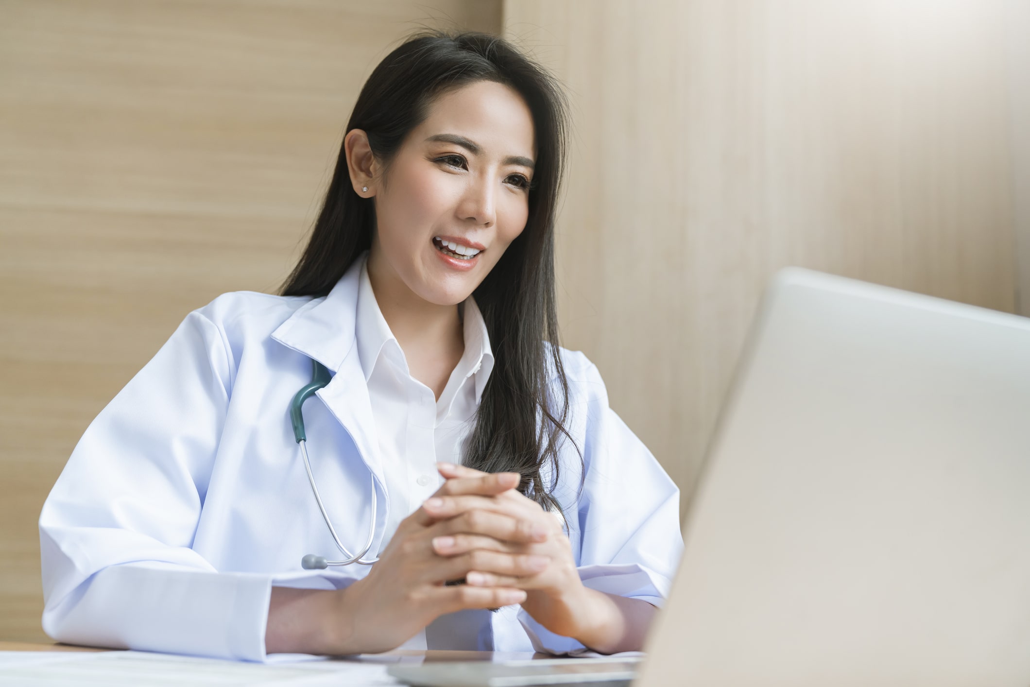 smiling female doctor on laptop