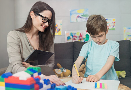 Female school therapist working with male child