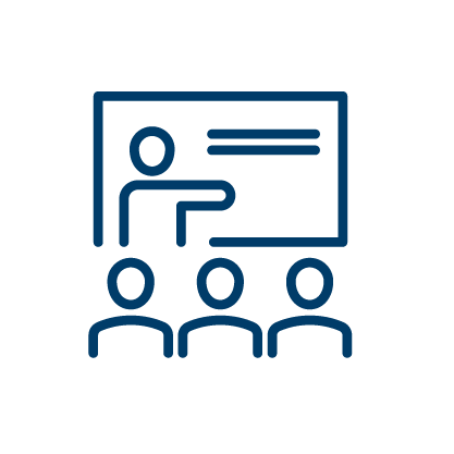 students sitting down looking at a teacher at the whiteboard